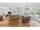 Spacious living area with hardwood flooring, fireplace and natural light and dining area at 5054 Kingsbridge Pass, Powder Springs, GA 30127