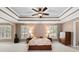 Spacious main bedroom with tray ceiling, carpet flooring, and ample natural light at 5054 Kingsbridge Pass, Powder Springs, GA 30127