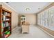 Home office with a built-in bookshelf, desk, and a window with plantation shutters at 5054 Kingsbridge Pass, Powder Springs, GA 30127