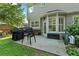 Back patio featuring a grill and table set in an open backyard at 5054 Kingsbridge Pass, Powder Springs, GA 30127
