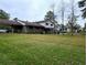 Expansive backyard with lush green grass and mature trees offering shade at 7437 Grayson Dr, Riverdale, GA 30296