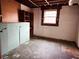 Unfinished basement with pegboard, shelves, and a window at 7437 Grayson Dr, Riverdale, GA 30296