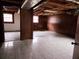 Unfinished basement with tile floor, paneled wall and natural light at 7437 Grayson Dr, Riverdale, GA 30296