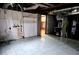 Unfinished basement with tile flooring and exposed ceiling at 7437 Grayson Dr, Riverdale, GA 30296