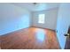 Bright and airy bedroom with hardwood floors and a large window for ample natural light at 7437 Grayson Dr, Riverdale, GA 30296