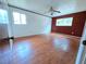Spacious bedroom with hardwood floors, two windows, and a ceiling fan at 7437 Grayson Dr, Riverdale, GA 30296