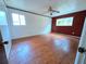Spacious bedroom with hardwood floors, two windows, and a ceiling fan at 7437 Grayson Dr, Riverdale, GA 30296