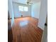 Bright bedroom featuring hardwood floors, a ceiling fan, and a window with natural light at 7437 Grayson Dr, Riverdale, GA 30296