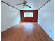 Bedroom with hardwood flooring, ceiling fan, window, and neutral-colored walls at 7437 Grayson Dr, Riverdale, GA 30296