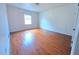 Bright bedroom with hardwood floors and natural light from a window at 7437 Grayson Dr, Riverdale, GA 30296