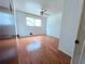 Bedroom featuring hardwood floors, a window, and a ceiling fan at 7437 Grayson Dr, Riverdale, GA 30296