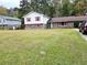 Split-level home with brick and siding, features a front yard and carport at 7437 Grayson Dr, Riverdale, GA 30296