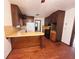 Kitchen with breakfast bar and wooden floors, illuminated by a window and view of range at 7437 Grayson Dr, Riverdale, GA 30296