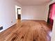 Living room with hardwood floors and natural light, adjoining a doorway at 7437 Grayson Dr, Riverdale, GA 30296