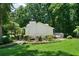 A backyard view of the home featuring a wooden deck, lush landscaping, and mature trees for privacy at 86 Kelly Ct, Dallas, GA 30157