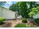 Exterior view of backyard deck, lush greenery, and shed at 86 Kelly Ct, Dallas, GA 30157