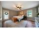 Comfortable bedroom with neutral paint, fan, wood floor, and chest at the base of the bed at 86 Kelly Ct, Dallas, GA 30157