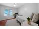 Cozy bedroom with a ceiling fan, light-colored walls, wood floor, and a view to outside at 86 Kelly Ct, Dallas, GA 30157