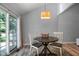 Cozy dining area features hardwood floors, a stylish light fixture, and a sliding glass door, filling the room with light at 86 Kelly Ct, Dallas, GA 30157