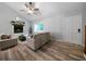 Bright living room showcases hardwood floors, a fireplace, and neutral-toned furniture, illuminated by natural light at 86 Kelly Ct, Dallas, GA 30157