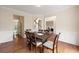 Open-concept dining area with hardwood floors, traditional wood trim, and easy access to kitchen at 1413 Eastbrooke Way, Marietta, GA 30066