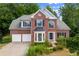 Charming two-story brick home with a well-manicured front yard and attached two car garage at 1413 Eastbrooke Way, Marietta, GA 30066