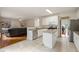 Modern kitchen with granite countertops, white cabinets, and stainless steel appliances with an open view to living area at 1413 Eastbrooke Way, Marietta, GA 30066
