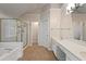 Luxurious main bathroom with a soaking tub, glass-enclosed shower, and and vanity at 1413 Eastbrooke Way, Marietta, GA 30066