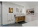 Bright bathroom features a double vanity, modern lighting, gray tile floors, and artwork at 3143 Church St, East Point, GA 30344
