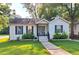 Charming single-story home featuring a manicured lawn and inviting front porch with updated door at 3143 Church St, East Point, GA 30344
