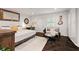 Cozy main bedroom featuring a comfortable queen-size bed, hardwood floors, and decorative accents at 3143 Church St, East Point, GA 30344