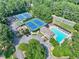Aerial view of community pool and tennis courts, surrounded by lush greenery at 4211 Schooner Ne Ct, Roswell, GA 30075