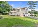 Spacious backyard with a well-maintained lawn, a deck, and mature trees at 4211 Schooner Ne Ct, Roswell, GA 30075