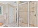Modern bathroom with a glass-enclosed shower, tiled walls, and a window for ventilation at 4211 Schooner Ne Ct, Roswell, GA 30075