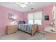 Inviting pink bedroom with a bed, dresser, and a window, creating a cozy and comfortable space at 4211 Schooner Ne Ct, Roswell, GA 30075