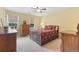 Comfortable bedroom with warm yellow walls, two windows, and classic wooden furniture providing storage at 4211 Schooner Ne Ct, Roswell, GA 30075