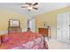 Inviting bedroom with warm walls, wooden furniture, and plenty of natural light, offering a cozy ambiance at 4211 Schooner Ne Ct, Roswell, GA 30075