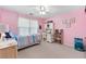 Charming pink bedroom with a bed, desk, and ample natural light, perfect for a or teen at 4211 Schooner Ne Ct, Roswell, GA 30075
