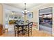 A dining room with a dark wood table and chairs in front of a sun room and a living room with a fireplace at 4211 Schooner Ne Ct, Roswell, GA 30075