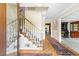 Inviting foyer with hardwood floors, staircase with white railings, and decorative rug at 4211 Schooner Ne Ct, Roswell, GA 30075