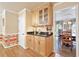 Kitchen coffee bar with wood cabinets and black countertop situated next to a doorway leading into a dining area at 4211 Schooner Ne Ct, Roswell, GA 30075