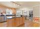 Kitchen island featuring wood cabinets and granite countertops, stainless steel sink, and hardwood floors at 4211 Schooner Ne Ct, Roswell, GA 30075
