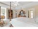 Spacious main bedroom featuring a four-poster bed, tray ceiling, and an ensuite bathroom for added privacy at 4211 Schooner Ne Ct, Roswell, GA 30075