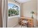Office nook with a wood desk, large windows offering backyard views and natural light at 4211 Schooner Ne Ct, Roswell, GA 30075