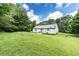 Expansive backyard featuring a well-maintained lawn and privacy from surrounding mature trees at 504 Azalea Ct, Woodstock, GA 30188