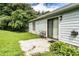 Outdoor space with a concrete patio surrounded by green grass and bushes, perfect for outdoor enjoyment at 504 Azalea Ct, Woodstock, GA 30188