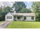 Classic one-story home with an attached garage and a well-maintained front lawn, creating a welcoming curb appeal at 504 Azalea Ct, Woodstock, GA 30188