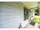 Close up of the entrance with painted siding and storm door, offering an inviting space to greet visitors at 504 Azalea Ct, Woodstock, GA 30188