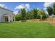 A spacious, well-maintained backyard with lush green grass and a covered patio area at 515 Cobblestone Ct, Canton, GA 30115