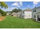 The large backyard features a covered patio with a well maintained lawn and surrounding neighborhood views at 515 Cobblestone Ct, Canton, GA 30115